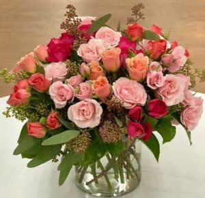 Cheerful spray roses in shades of pink accented with greenery