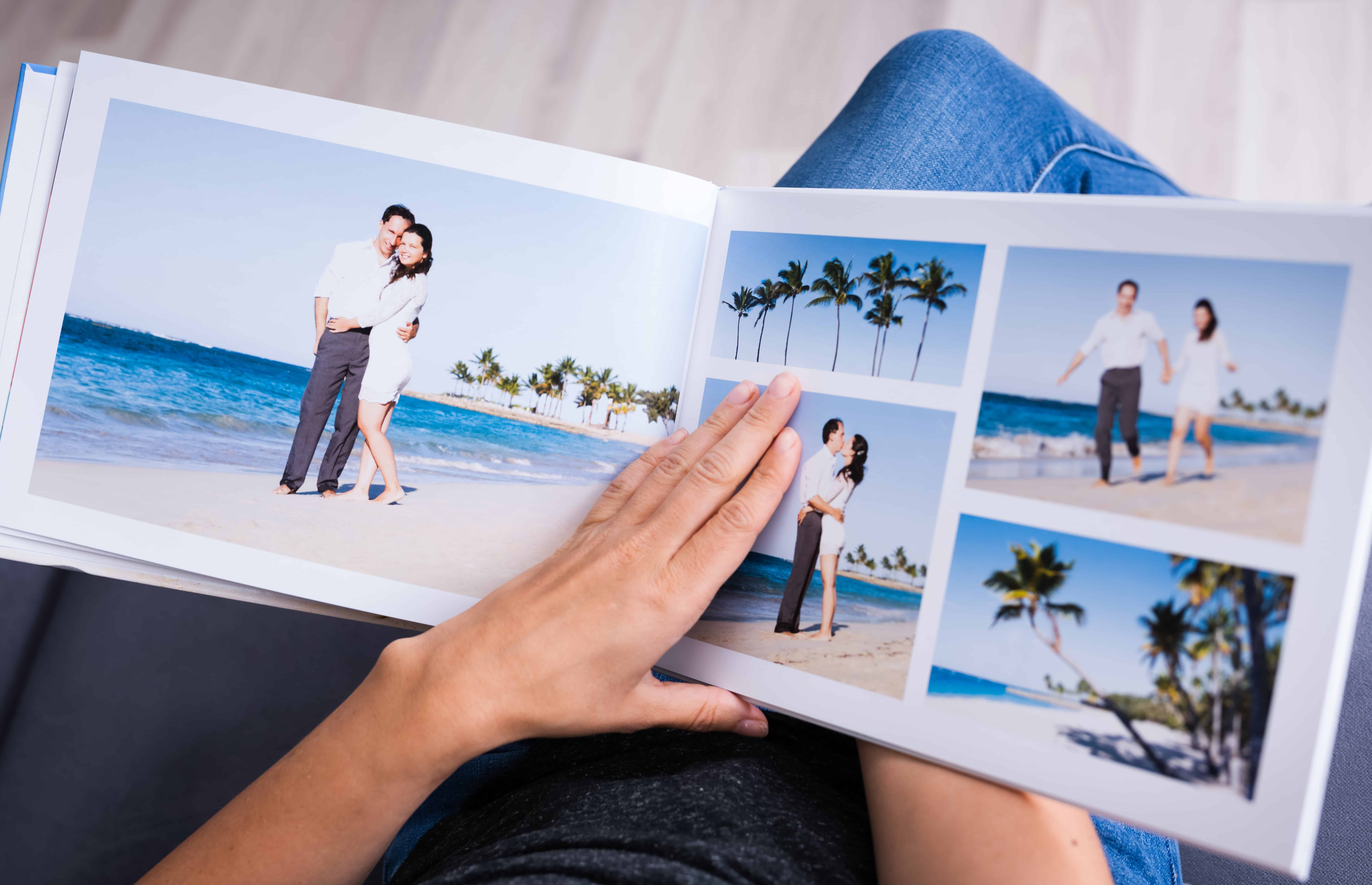 open photo book to pictures of couple on beach